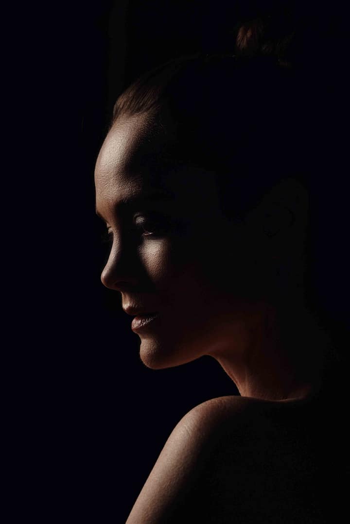 Female model in moody profile beauty portrait with somber expression. Shot in studio by Stefan Venter Photography in Cape Town, South Africa. Art and portrait photographer Cape Town - Stefan Venter