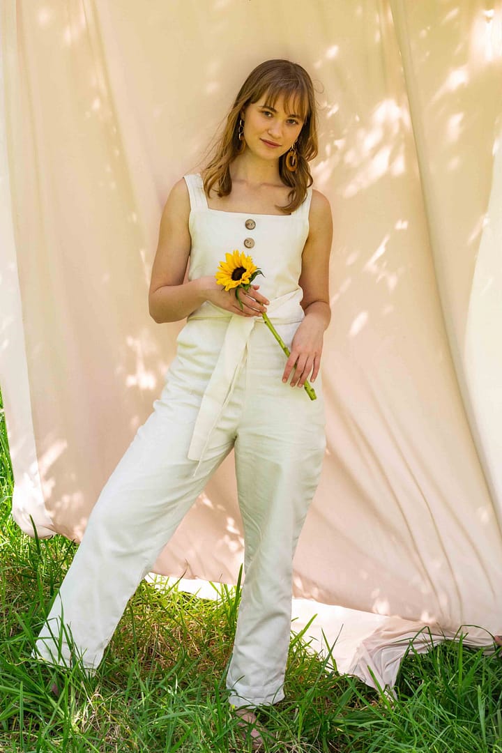 Blonde model in linen jumpsuit with sunflower, Cape Town photographed by Stefan Venter