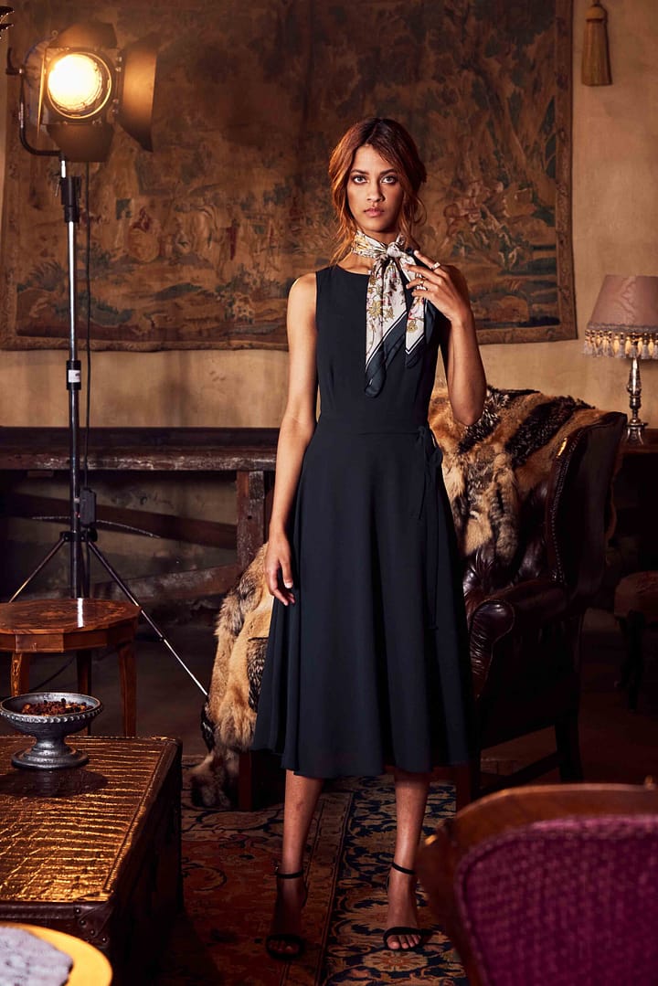 Extravagant and serious model in warm luxury lounge setting showing confidence. Paarl, Cape Town, South Africa. Photographer Stefan Venter.