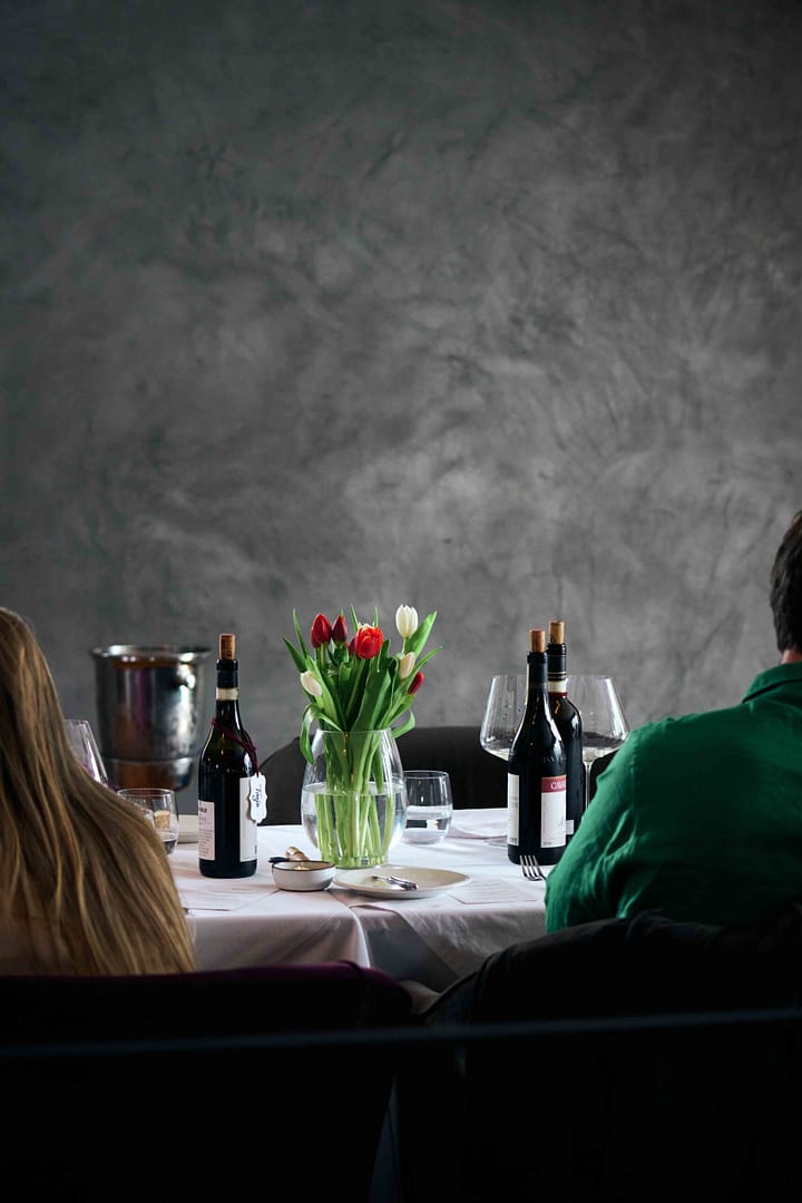 Dressed table with people and premium wines at Rueda Wine Co exclusive event held at noop restaurant in Paarl, Cape Town. Event by Stefan Venter Photography. Event photographer Cape Town - Stefan Venter