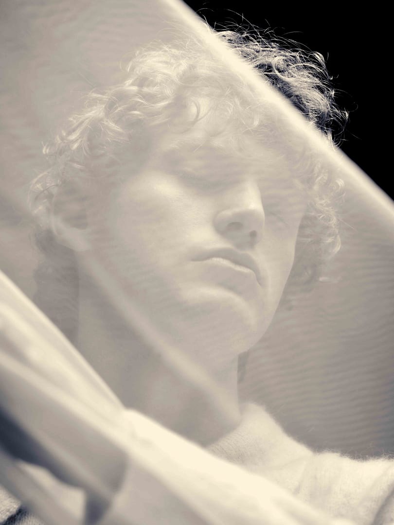 Moody Conceptual art portrait of ginger male model by Stefan Venter Photography. Personal project in collaboration with Neil Doveton in Cape Town. Draped cloth, black and white.