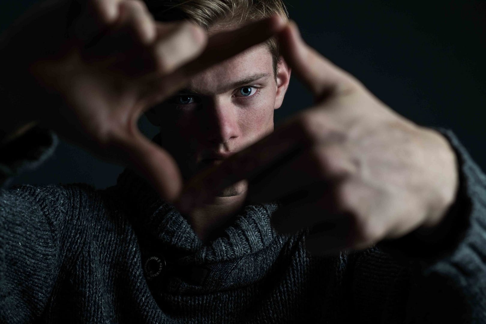 Male model in moody portrait with stern expression in jersey. Shot in studio by Stefan Venter Photography in Cape Town, South Africa.